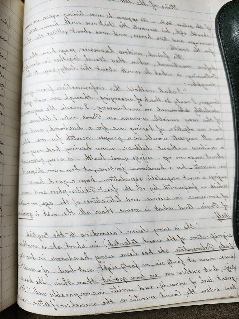 A color photograph of a lined journal page with very neat cursive handwriting on it. The quote above is towards the bottom of the page. 