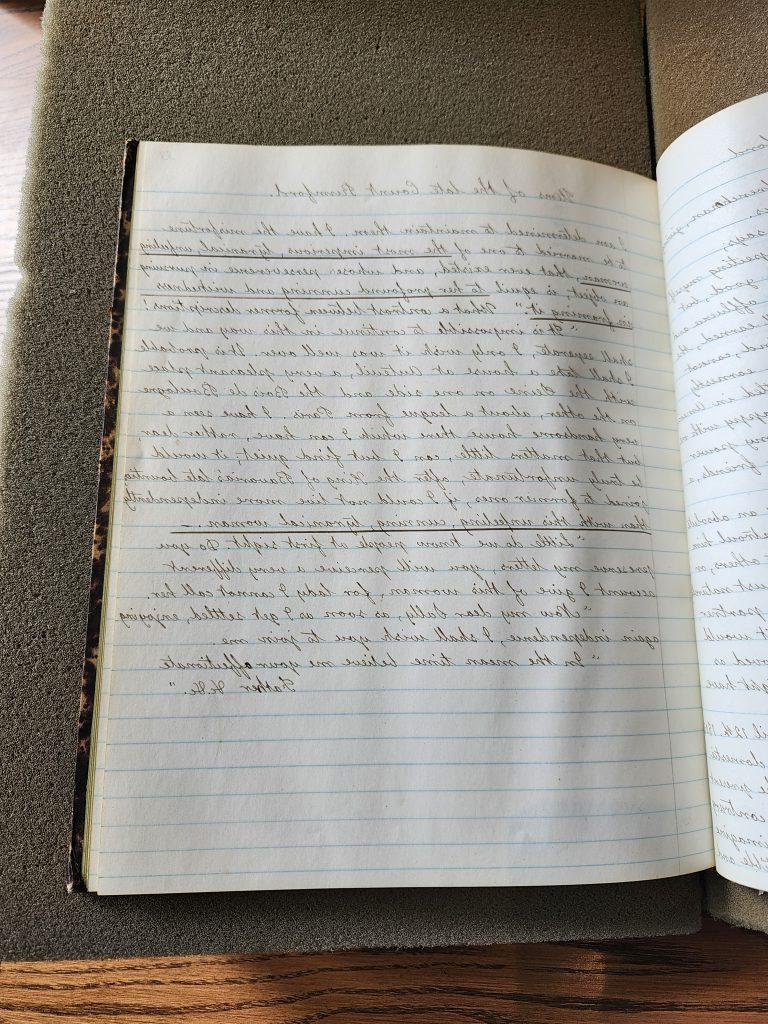 Color photograph of a lined open journal with very neat cursive handwriting in black ink. The quote above is in the first paragraph. 